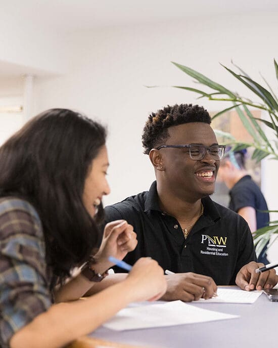 Students sit at a table in the University dorms